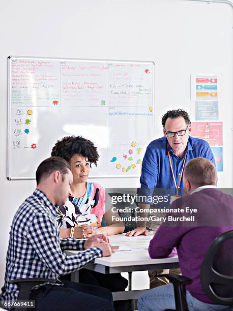 colleagues brainstorming in tech start-up office - gary burchell stock pictures, royalty-free photos & images