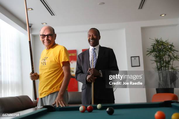 Housing and Urban Development Secretary Ben Carson plays pool against Armando de la Noval as he visits Colllins Park apartment complex on April 12,...