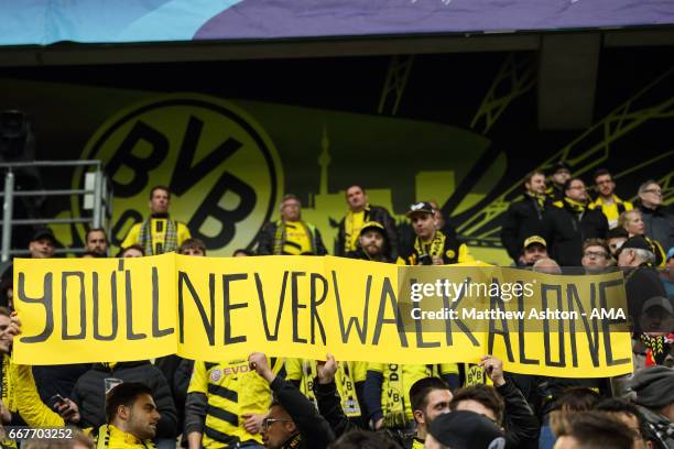 Fans of Borussia Dortmund hold up a banner saying You'll Never Walk Alone before the UEFA Champions League Quarter Final first leg match between...