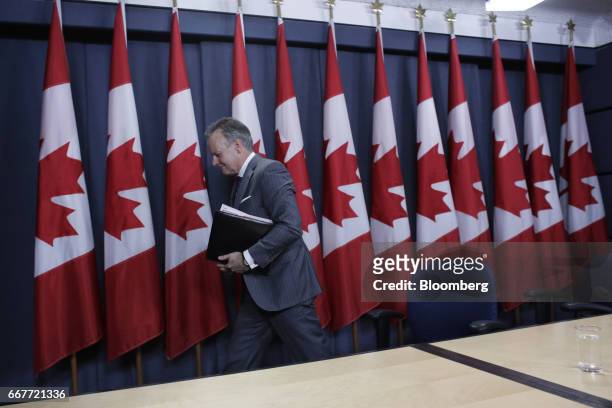 Stephen Poloz, governor of the Bank of Canada, exits after a news conference at the National Press Theatre in Ottawa, Ontario, Canada, on Wednesday,...