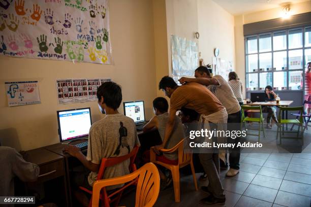 Afghan illegal migrants and asylum seekers check their Facebook pages at the NGO Praksis, which provides services to migrant youths at their center...