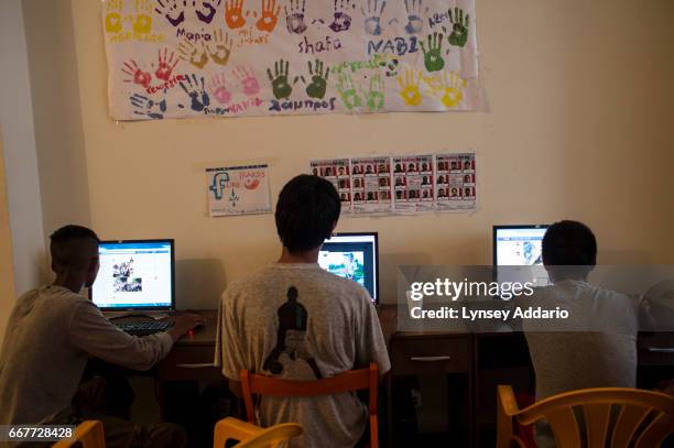 Afghan illegal migrants and asylum seekers check their Facebook pages at the NGO Praksis, which provides services to migrant youths at their center...