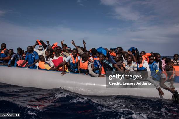 Italian sailors with the Uraniam Navy Ship rescue 109 African migrants from Gambia, Mali, Senegal, Ivory Coast, Guinea, and Nigeria, from a rubber...