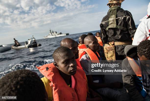 Italian sailors with the Uraniam Navy Ship rescue African migrants from Gambia, Mali, Senegal, Ivory Coast, Guinea, and Nigeria, from a rubber boat...