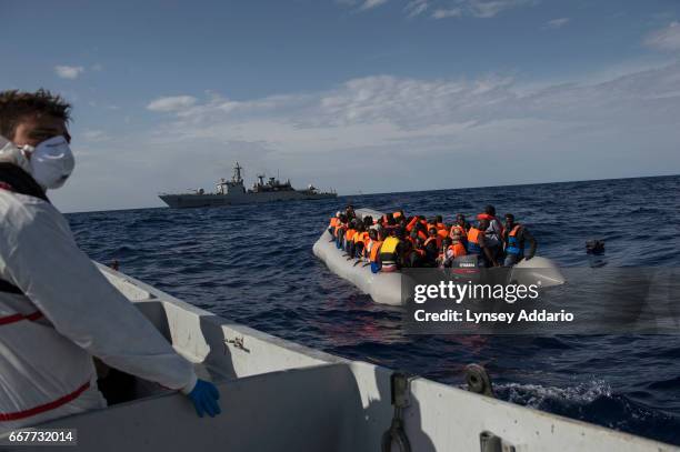 Italian sailors with the Uraniam Navy Ship rescue African migrants from Gambia, Mali, Senegal, Ivory Coast, Guinea, and Nigeria, from a rubber boat...