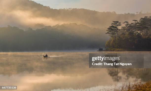 man on misty lake - archipiélago malayo fotografías e imágenes de stock