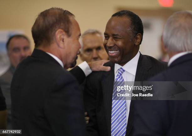 Housing and Urban Development Secretary Ben Carson speaks with Jorge Perez, CEO, Related Urban Group during a visit to the Liberty Square apartment...