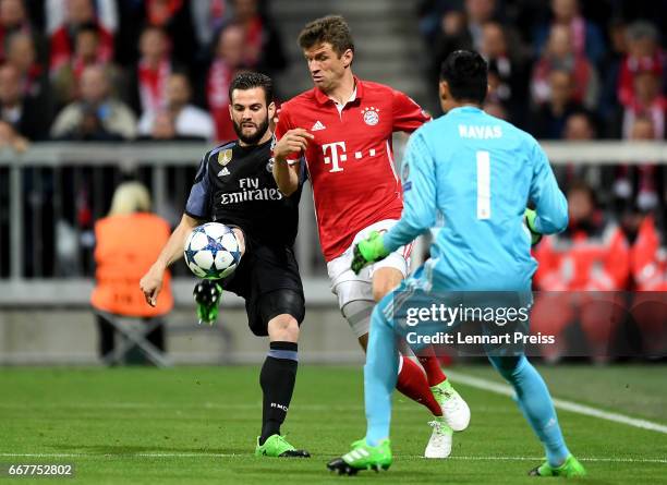 Thomas Mueller of Bayern is challenged by Nacho of Real Madrid during the UEFA Champions League Quarter Final first leg match between FC Bayern...