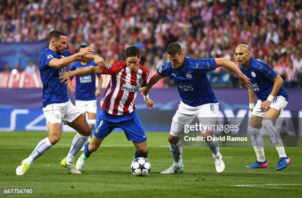 Fernando Torres of Atletico Madrid is challenged by Danny Drinkwater and Robert Huth of Leicester City during the UEFA Champions League Quarter Final...