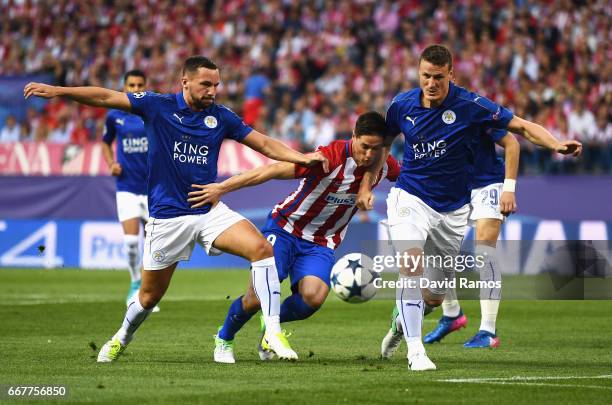 Fernando Torres of Atletico Madrid is challenged by Danny Drinkwater and Robert Huth of Leicester City during the UEFA Champions League Quarter Final...