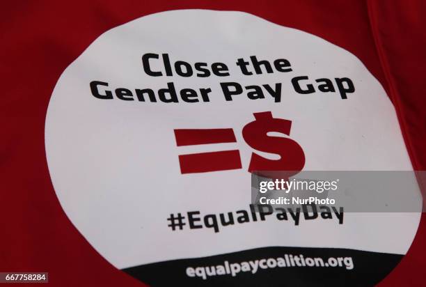 Close-up of a banner as women rally to demand equal pay for women and an end to the wage gap between the sexes on 'Equal Pay Day' in Toronto,...