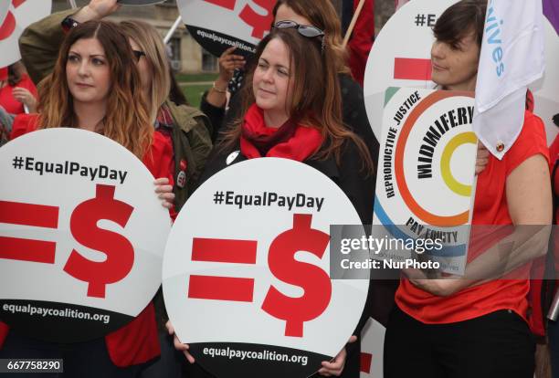 Women rally to demand equal pay for women and an end to the wage gap between the sexes on 'Equal Pay Day' in Toronto, Ontario, Canada, on April 11,...