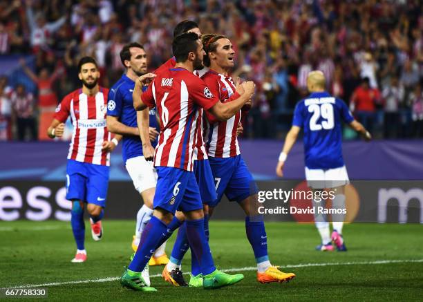 Antoine Griezmann of Atletico Madrid celebrates with team mates after scoring his team's first goal of the game from the penalty spot during the UEFA...