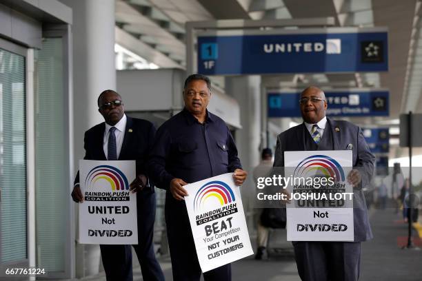 Reverend Jesse Jackson holds a sign as he protest against United Airlines at O'Hare International Airport on April 12, 2017 in Chicago, Illinois. The...