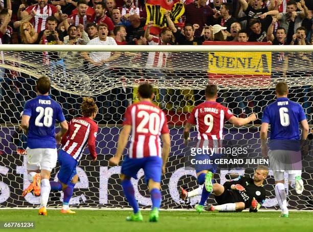 Atletico Madrid's French forward Antoine Griezmann scores a goal after shooting a penalty kick during the UEFA Champions League quarter final first...