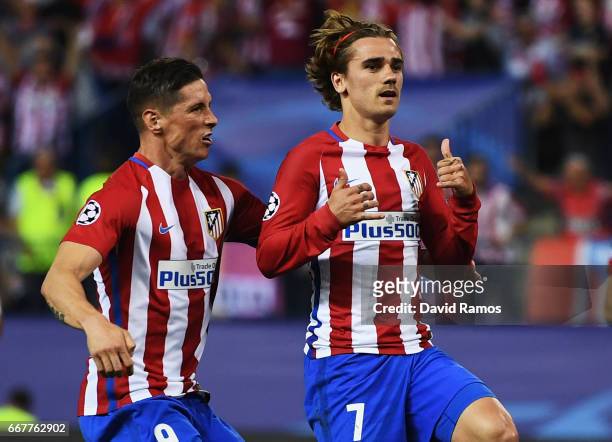 Antoine Griezmann of Atletico Madrid celebrates with team mate Fernando Torres after scoring the opening goal of the game during the UEFA Champions...