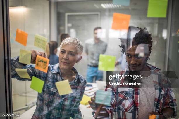 designers creating a mind map on a meeting in the office. - labelling stock pictures, royalty-free photos & images