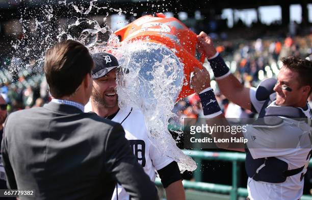 James McCann of the Detroit Tigers dumped water on teammate Andrew Romine during the post game interviews after the game against the Minnesota Twins...
