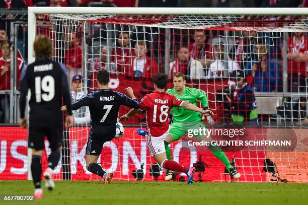 Madrid's Portuguese forward Cristiano Ronaldo scores the second goal during the UEFA Champions League 1st leg quarter-final football match FC Bayern...