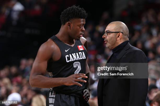 Luguentz Dort chats with Head Coach Roy Rana of the World Select Team shoots a free-throw against the USA Junior Select Team during the game on April...