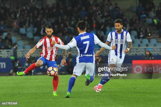 Carlos Carmona of Sporting Gijon duels for the ball with Juanmi of Real Sociedad during the Spanish league football match between Real Sociedad and...