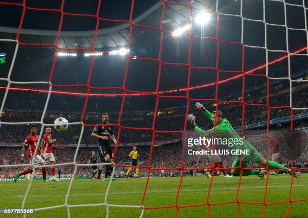Bayern Munich's goalkeeper Manuel Neuer misses a goal from Real Madrid's Portuguese forward Cristiano Ronaldo during the UEFA Champions League 1st...
