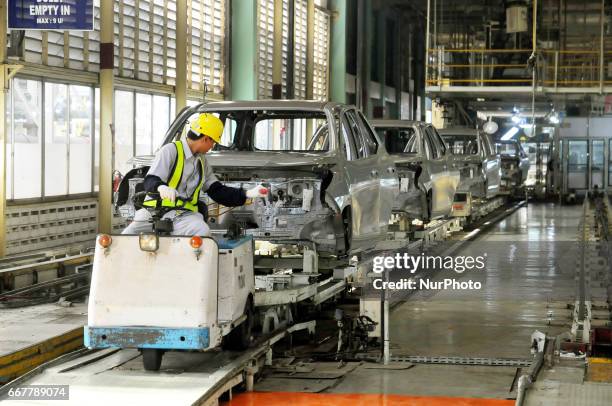 Workers connect components to be a car body plate at Toyota Motor Manufacturing Indonesia, Karawang, West Java, on March 29, 2017. The Company Toyota...