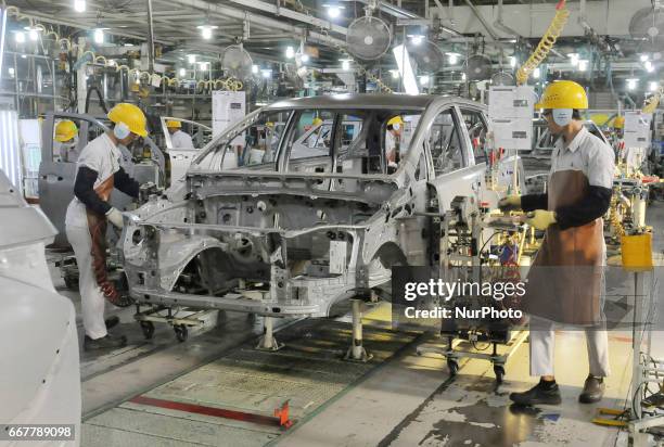 Workers connect components to be a car body plate at Toyota Motor Manufacturing Indonesia, Karawang, West Java, on March 29, 2017. The Company Toyota...