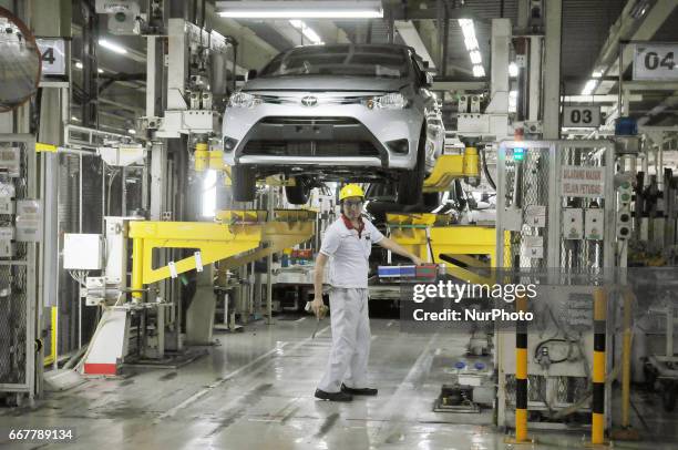 Workers assemble these parts into a car at Toyota Motor Manufacturing Indonesia, Karawang, West Java, on March 30, 2017. The Company Toyota Motor...