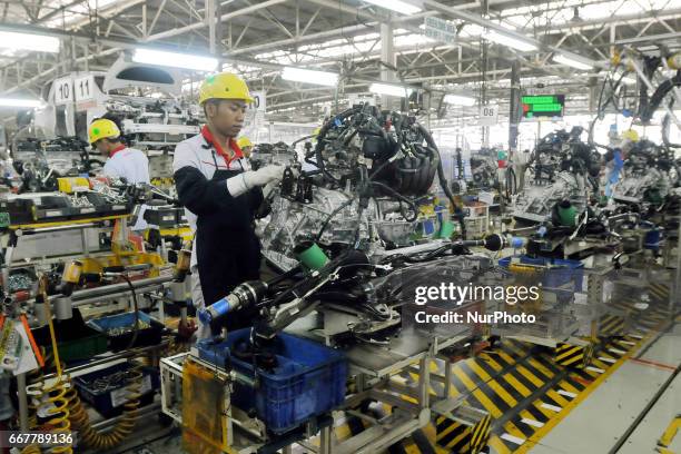 Workers assemble these parts into a car at Toyota Motor Manufacturing Indonesia, Karawang, West Java, on March 30, 2017. The Company Toyota Motor...