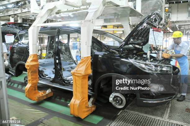 Workers installing components to automobile vehicles at Toyota Motor Manufacturing Indonesia, Karawang, West Java, on March 31,2017. Toyota Motor...