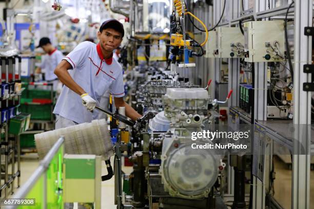 Workers ready to plug in a car engine at Toyota Motor Manufacturing Indonesia, Karawang, West Java, on April 4, 2017. The Company Toyota Motor...