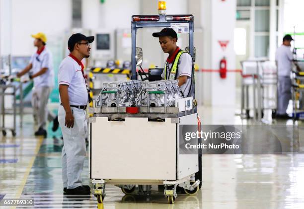 Workers ready to plug in a car engine at Toyota Motor Manufacturing Indonesia, Karawang, West Java, on APRIL 4, 2017. The Company Toyota Motor...