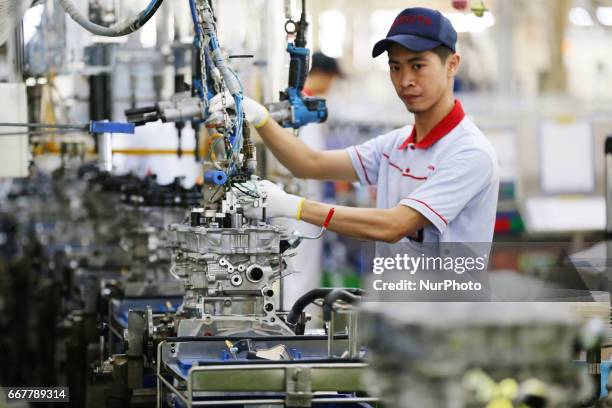 Workers ready to plug in a car engine at Toyota Motor Manufacturing Indonesia, Karawang, West Java, on April 2017. The Company Toyota Motor...