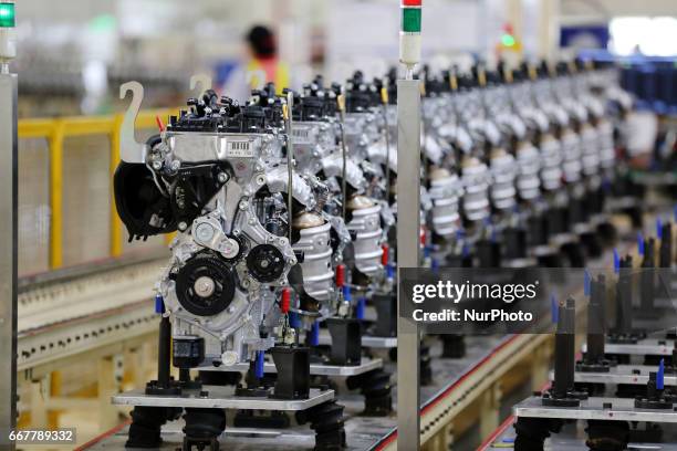 Workers ready to plug in a car engine at Toyota Motor Manufacturing Indonesia, Karawang, West Java, on April 2017. The Company Toyota Motor...