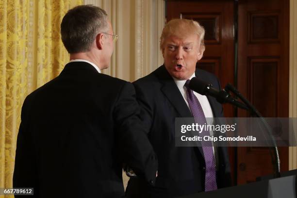 Secretary General Jens Stoltenberg and U.S. President Donald Trump shake hands at the conclusion of a news conference in the East Room of the White...