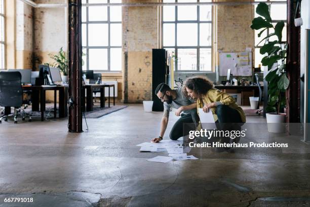 co-workers in startup business with business documents - office floor stock pictures, royalty-free photos & images