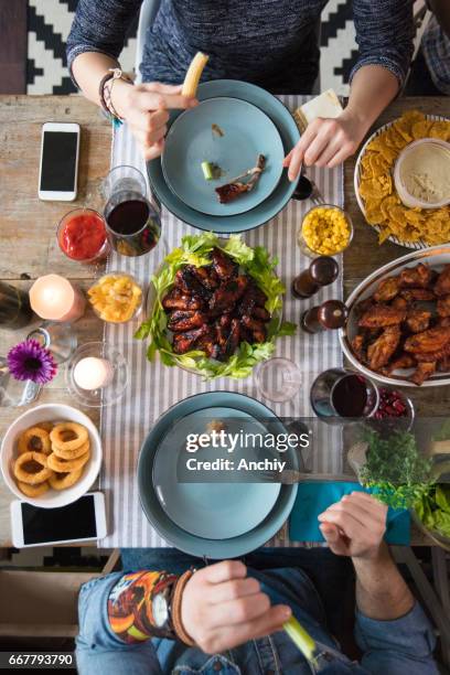 couple having a romantic date - hand chicken wing stock pictures, royalty-free photos & images