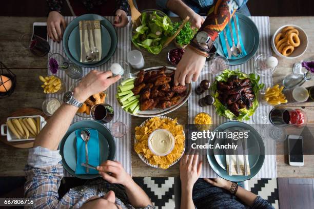 let's enjoy this delicious dinner - hand chicken wing stock pictures, royalty-free photos & images