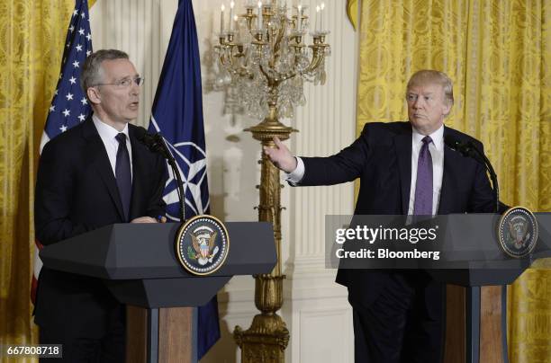 Jens Stoltenberg, secretary general of the North Atlantic Treaty Organization , left, speaks as U.S. President Donald Trump gestures during a joint...