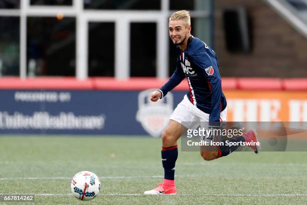 New England Revolution midfielder Diego Fagundez looks to pass carrying the ball through midfield during a regular season MLS match between the New...
