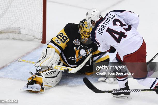 Pittsburgh Penguins Goalie Marc-Andre Fleury makes a save on Columbus Blue Jackets left wing Scott Hartnell in front during the first period in Game...