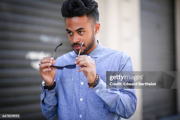 Theo Kimbaloula, fashion blogger, wears a Be Selective blue shirt, Be Selective pants, Jules white sneakers shoes, and a Diesel watch, on April 9,...