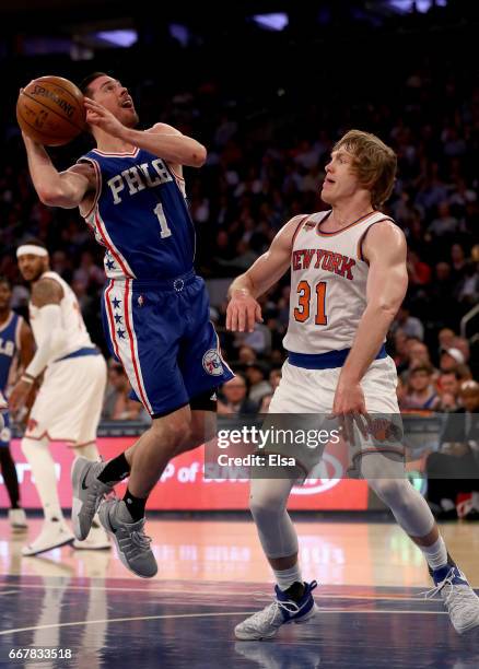McConnell of the Philadelphia 76ers heads for the net as Ron Baker of the New York Knicks defends at Madison Square Garden on April 12, 2017 in New...
