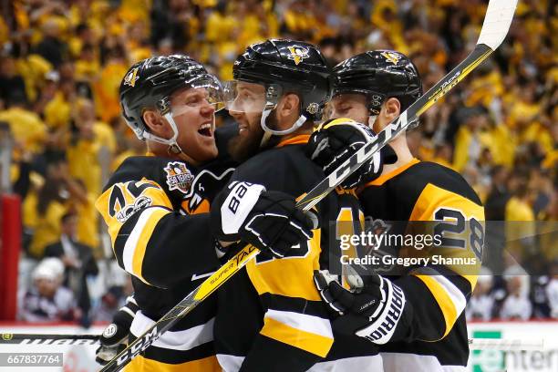 Nick Bonino of the Pittsburgh Penguins celebrates his second period goal with Patric Hornqvist and Ian Cole while playing the Columbus Blue Jackets...