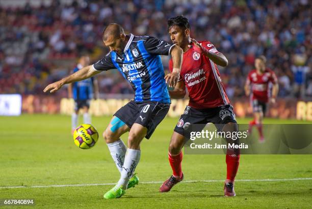 Emanuel Villa of Queretaro and Juan Carlos Valenzuela of Tijuana fight for the ball during the 10th round match between Queretaro and Tijuana as part...