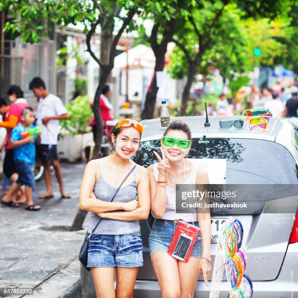 happy smiling thai women at songkran - songkran stock pictures, royalty-free photos & images