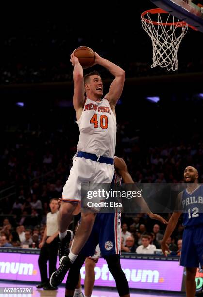 Marshall Plumlee of the New York Knicks dunks as Gerald Henderson of the Philadelphia 76ers defends at Madison Square Garden on April 12, 2017 in New...