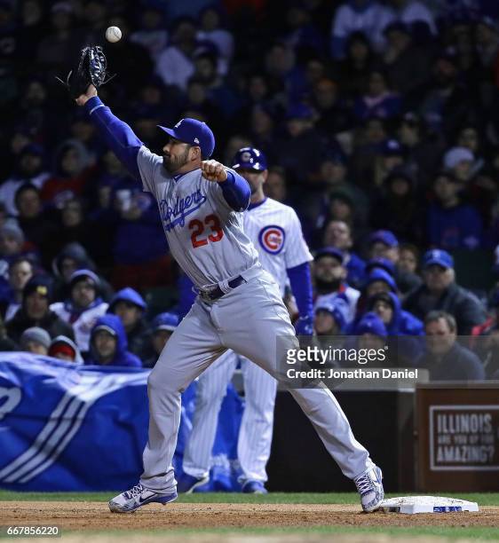 Adrian Gonzalez of the Los Angeles Dodgers misses the throw for an error in the 8th inning against the Chicago Cubs at Wrigley Field on April 12,...