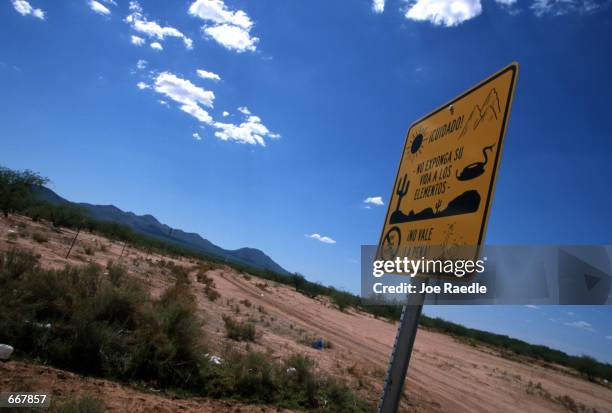 Sign near the barbed wire fence that marks the US/Mexico border warns immigrants July12, 2000 that they should not expose themselves to the harsh...